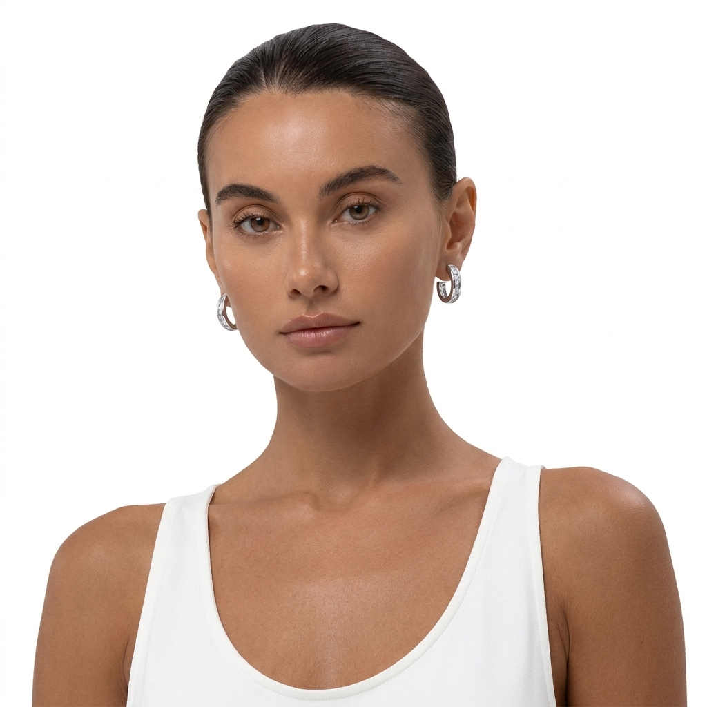 Front view of a model wearing Lumi silver-tone sparkle hoop earrings